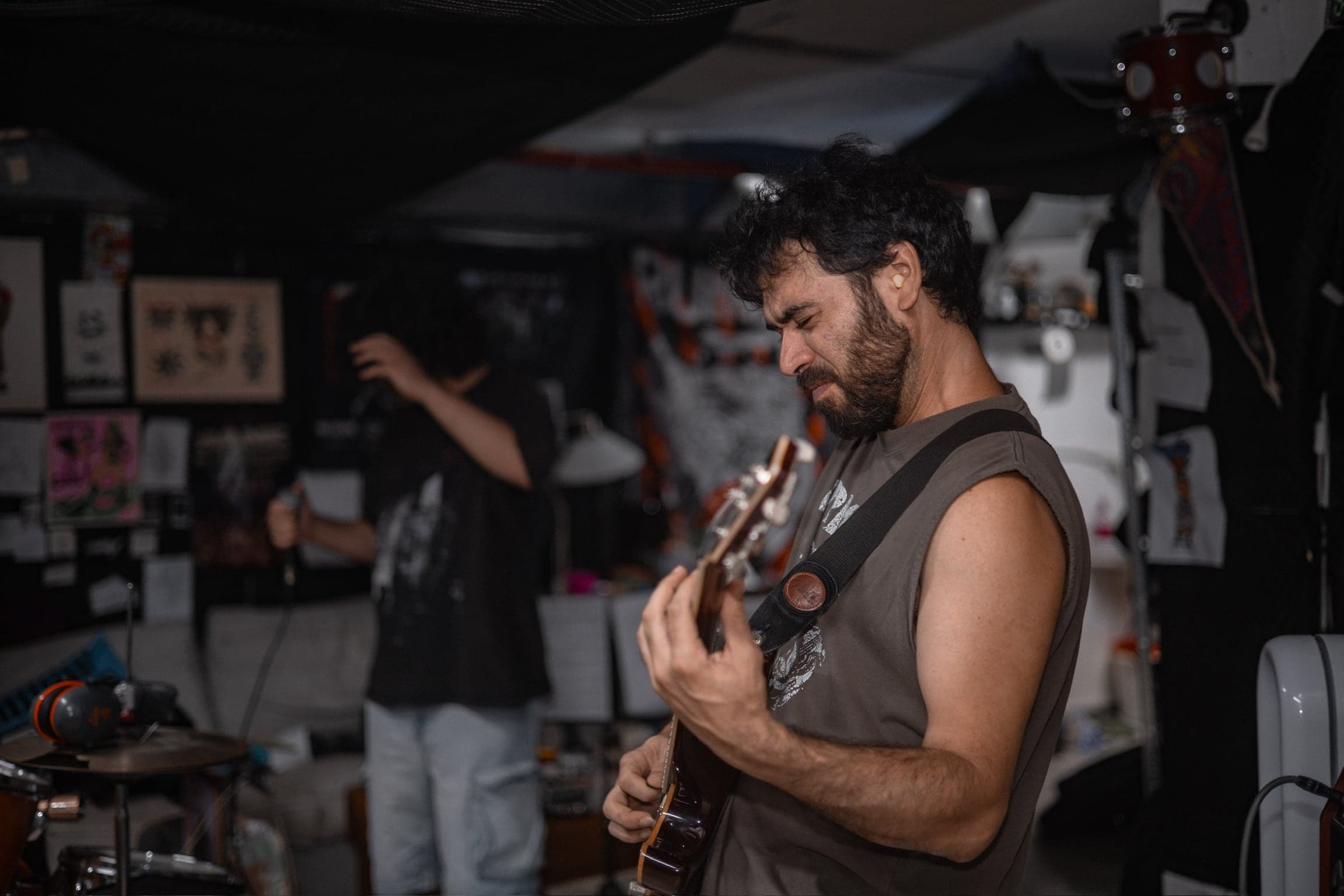 The guitarist works out a riff in profile, the vocalist a blur of motion in the background.