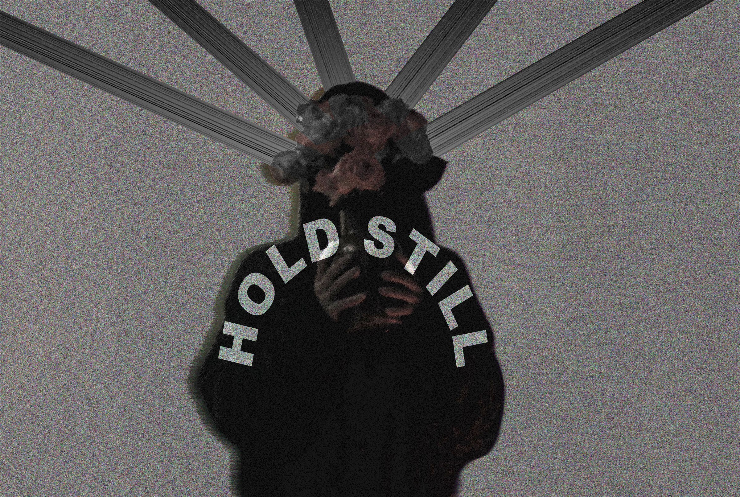 Nikki Freeman, grainy and silhouetted with an obscured floral head under radiating light beams, titled 'HOLD STILL.'